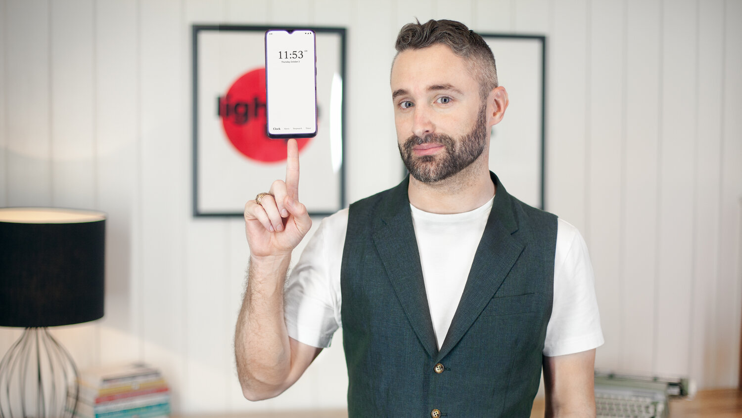 Chris Kaspar balancing a Wisephone smartphone on his finger.