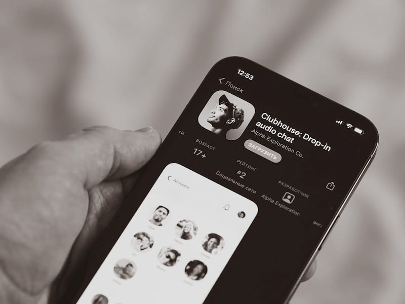 Clubhouse app on iPhone being held.